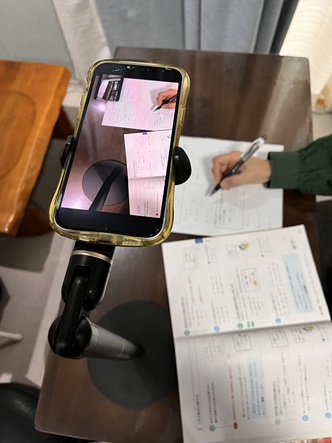 オンライン授業では、塾生はスマホでテキストを映し出されるようにし、先生から確認できるようにします。